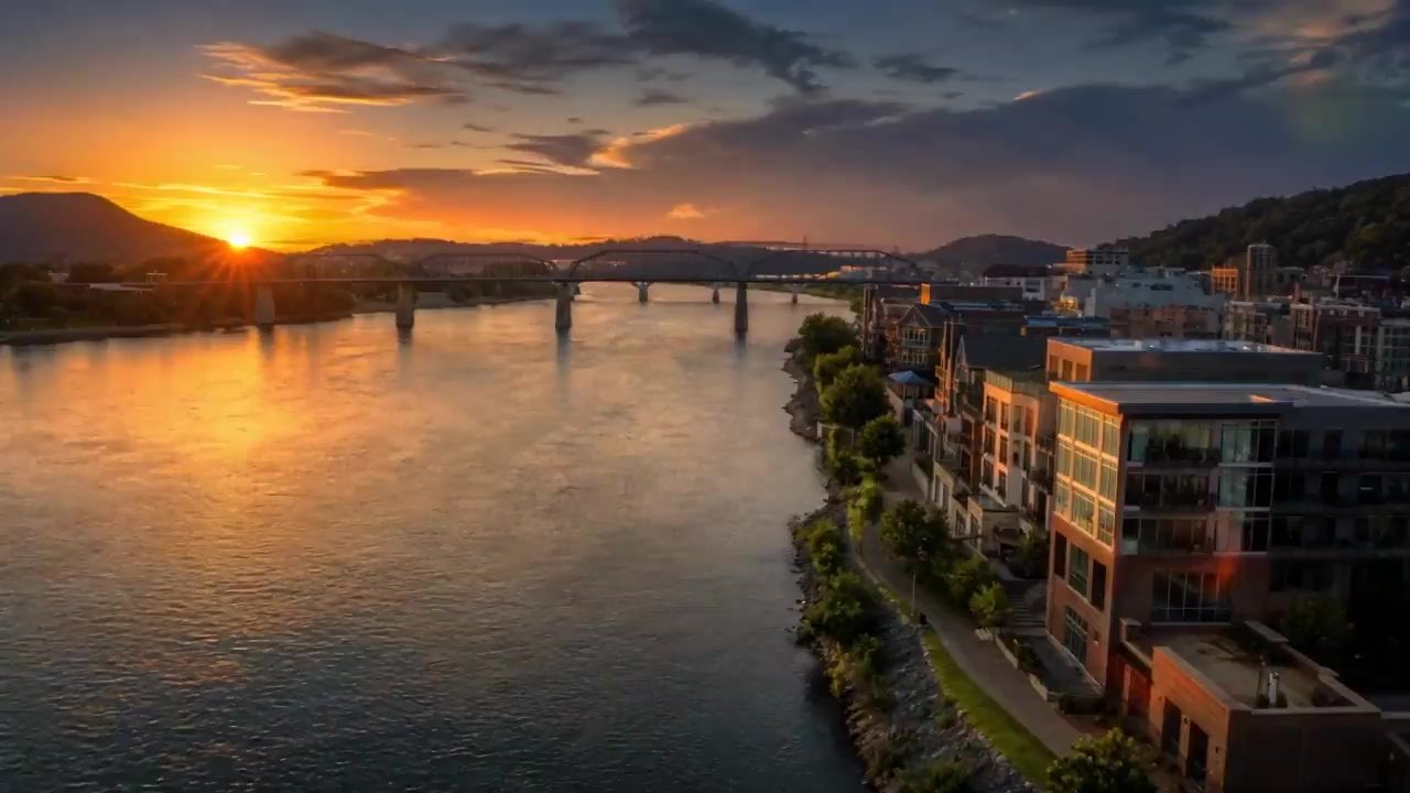 AI-generated concept image of the Chattanooga, Tennessee riverfront at sunset along the Tennessee River